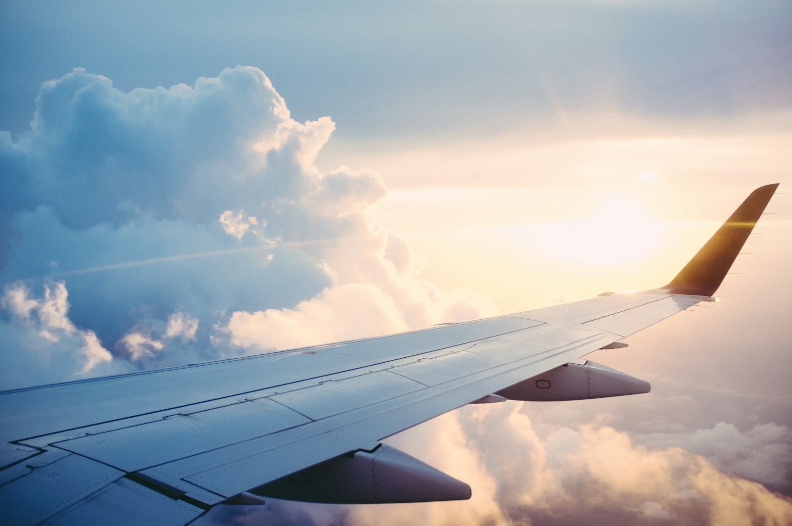 Aircraft above clouds — NRI travel and property investment in India