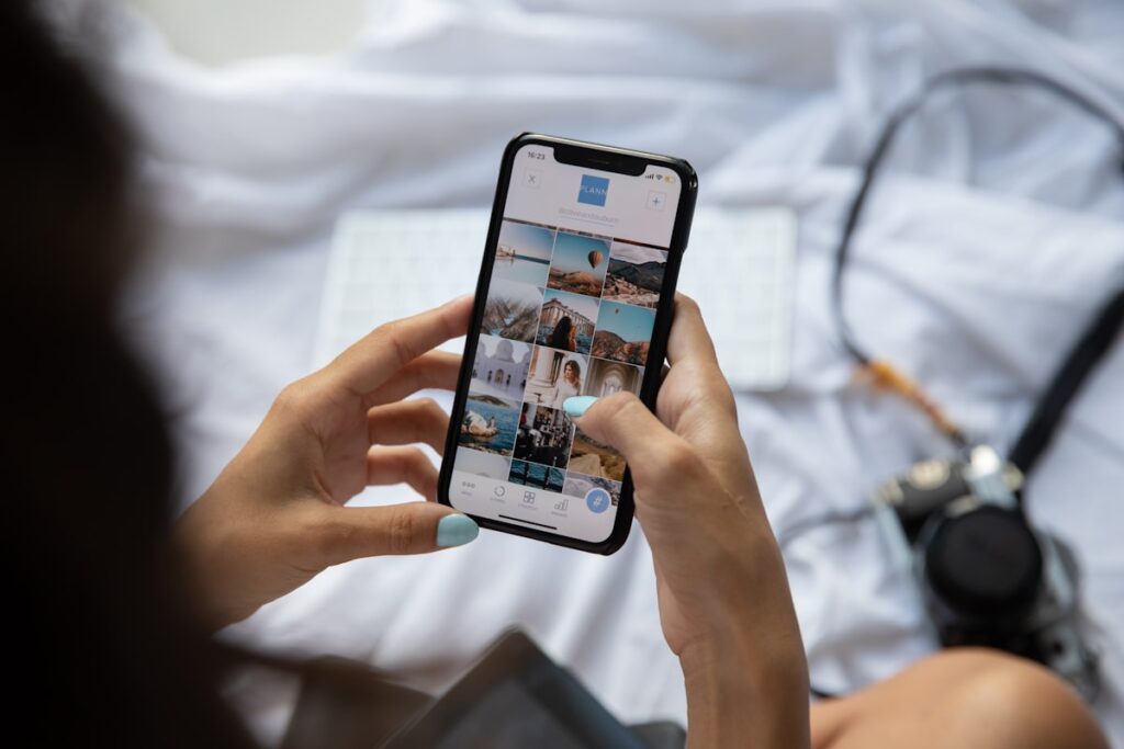 Person scrolling social media on a smartphone, illustrating how Google Ads vs Meta Ads for real estate reach buyers differently