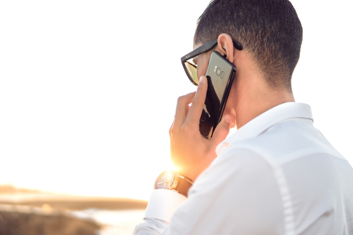 Salesperson checking phone for a fast speed to lead real estate response