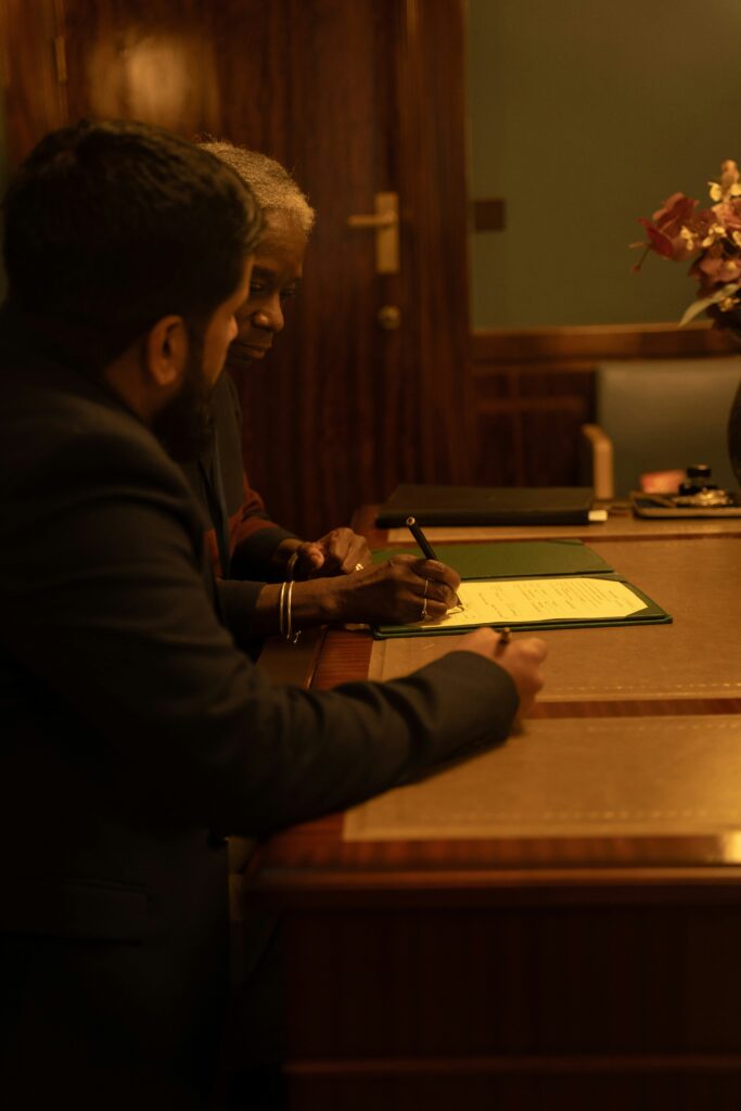 Buyer and seller reviewing registered property documents together