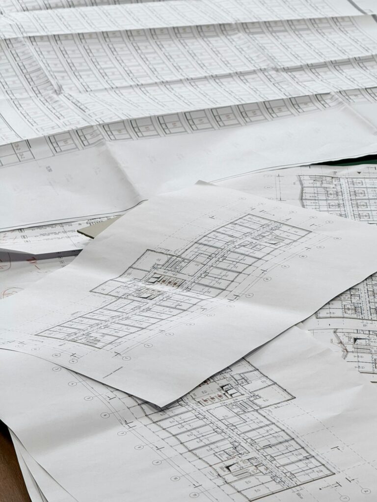 Layout plans of a licensed colony spread on a table