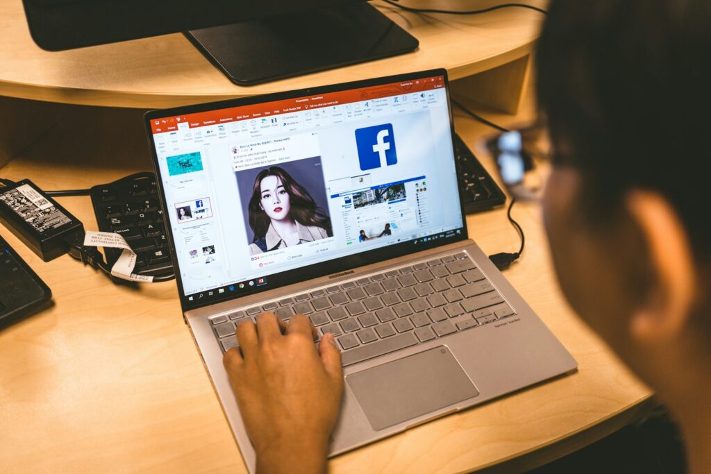 Laptop open on the Facebook Ad Library for real estate research