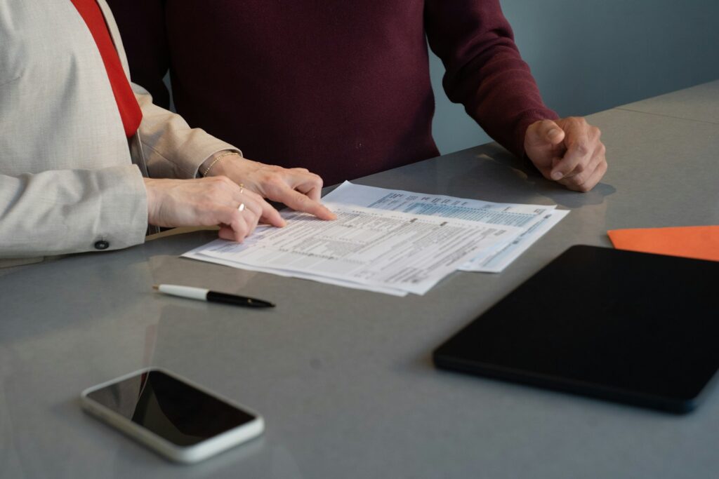 Two people reviewing documents for a real estate agent application