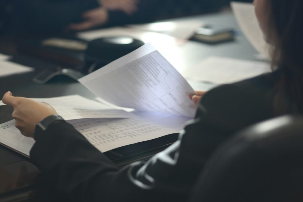 Promoter reviewing a quarterly progress report before filing