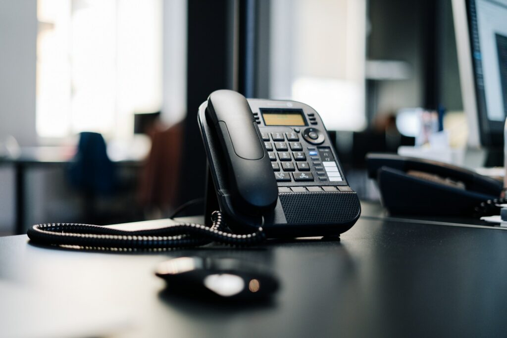 Office desk phone ringing with an enquiry from a Justdial listing