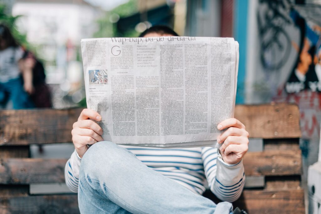 Reader going through Sunday property classifieds in a newspaper
