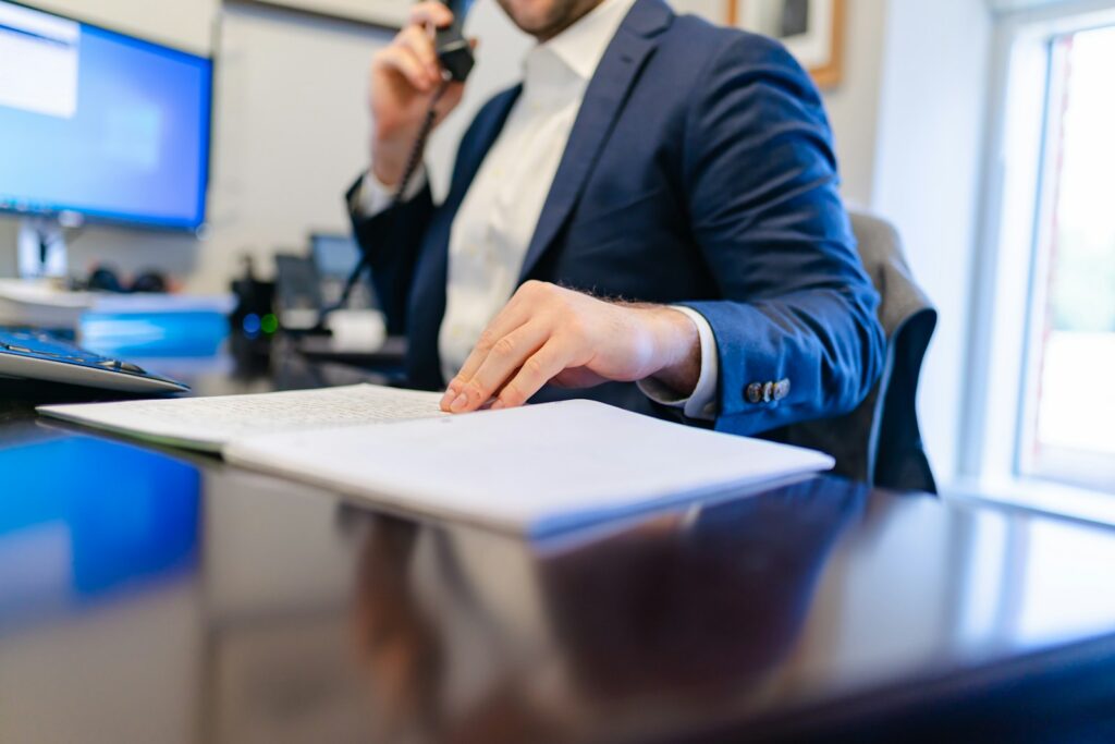 Dealer filling in a licence application form at a desk