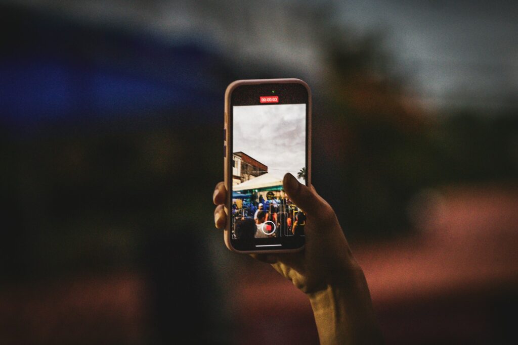 Agent filming a property walkthrough on a phone for Instagram