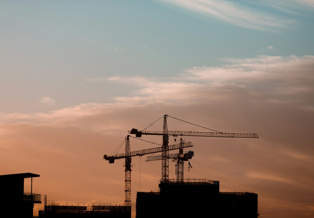 Three tower cranes over a housing project under construction