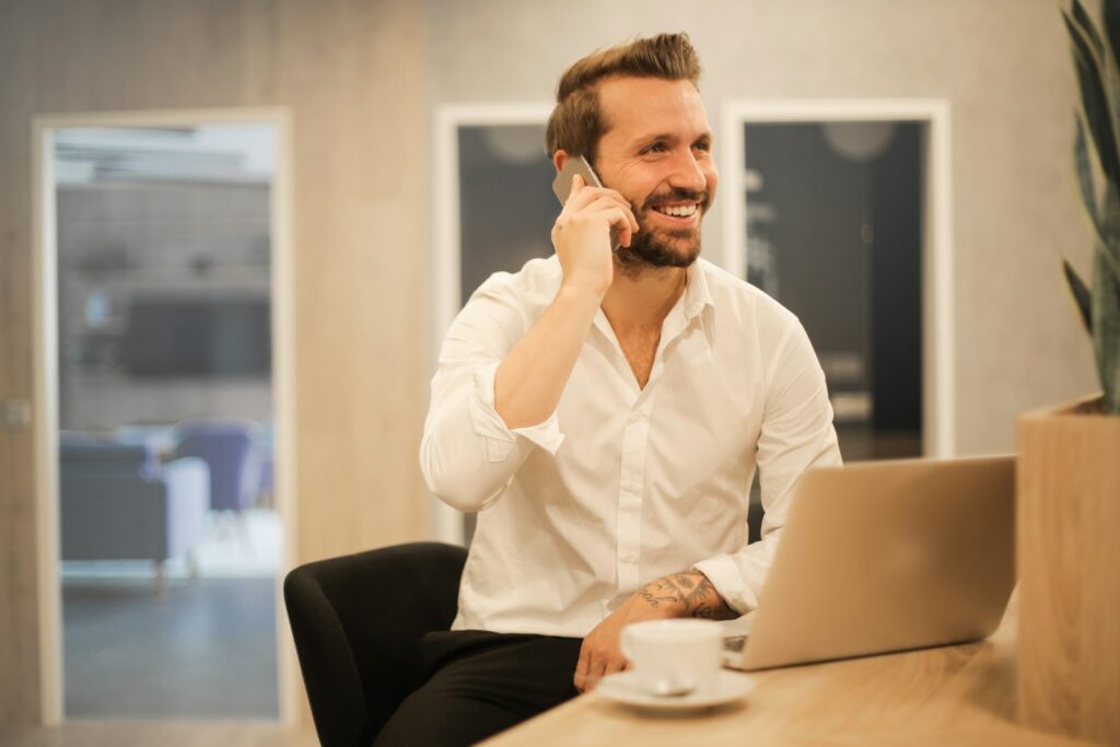 Property dealer calling a buyer while weighing the Truecaller Business price