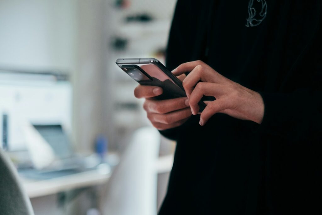 Buyer reading a project update on WhatsApp on an Android phone